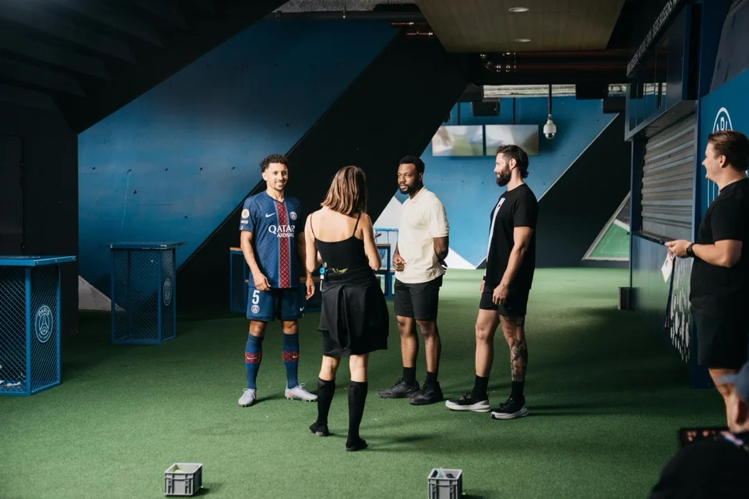 Marquinhos in PSG kit talking through a challenge with the crew at the stadium